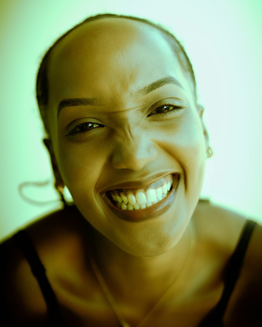 Studio portrait of a smiling woman with short hair