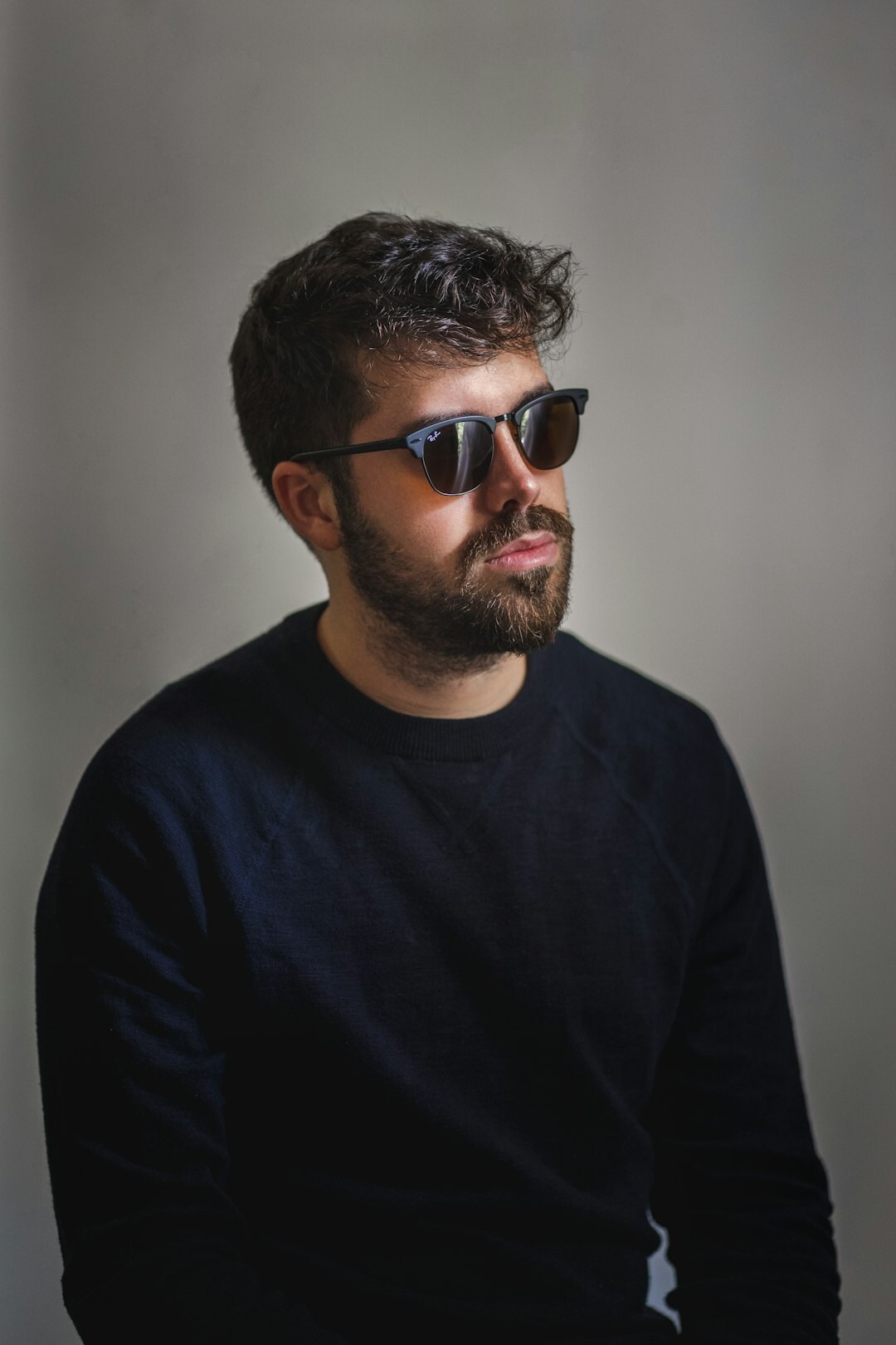 Studio portrait of a man with glasses and a beard